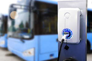 ev charger with blue buses in back